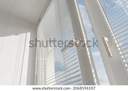 Open window. PVC plastic. Louver blinds.