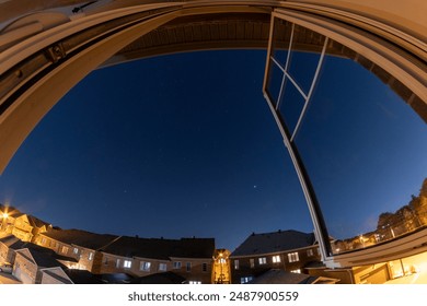 Open window view at twilight - starry sky above suburban neighborhood - curved perspective fisheye lens - tranquil evening ambiance - Powered by Shutterstock