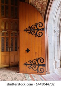 Open Wood Arched Door With Black Scroll Ironwork, Tile Floor, Stone Arch. Front Doors Of St Patrick's Cathedral, Catholic Church, Armagh, UK. 