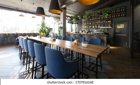 Open Wooden Bar Counter With Alcohol On Shelves In Modern Cafe, Restaurant Interior, Panorama, Copy Space