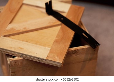 Open Wooden Crate With Crowbar