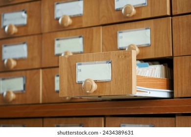 Open wooden drawer analogue paper filing cabinet number 38. Vintage information and data storage Place for inscription - mockup. Photo. Selective focusing. Natural lighting