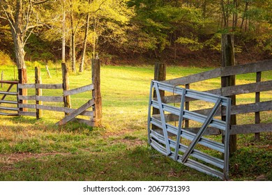 Open wooden and metal gate at entrance to grass field in rural setting  - Shutterstock ID 2067731393