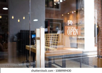 Open wooden sign broad through the glass in street cafe - Powered by Shutterstock