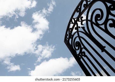 Open Wrought Iron Gate And Blue Sky On Background