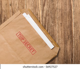 Open Yellow Envelope With Top Secret Stamp And Papers, On Wooden Table, Clipping Path.