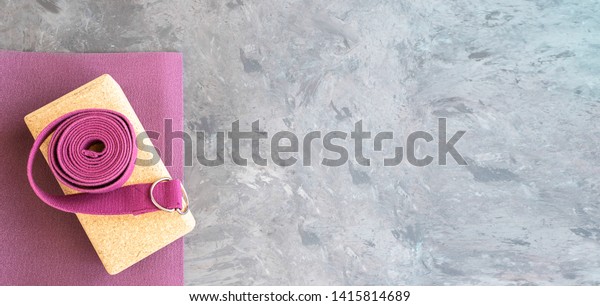 \
Open yoga mat with cork \
block and yoga strap Yoga practice props background. Copy\
space.\

