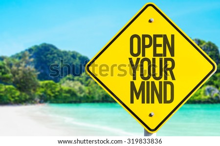 Open Your Mind sign with beach background