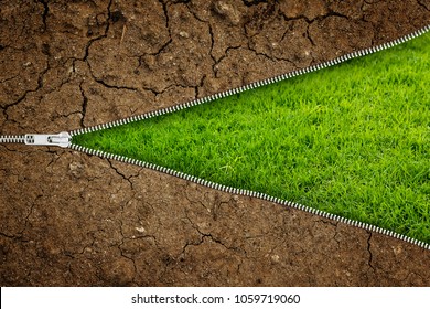 Open Zipper With Dry Soil On Fresh Green Grass With Copy Space For Your Text- Ecology Concept.