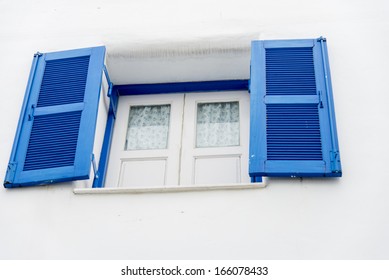 Opened blue window on white wall3
