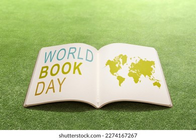 Opened book on the field. World Book Day Concept - Shutterstock ID 2274167267