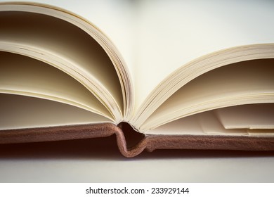 Opened book on the table. Close up.
