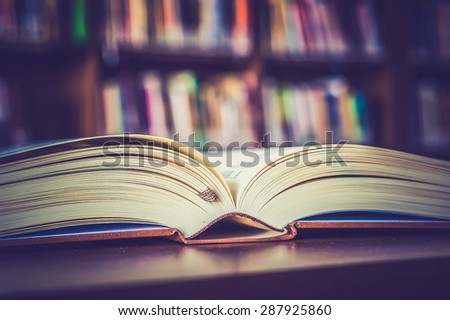 Opened book on the table in library - retro and vintage style