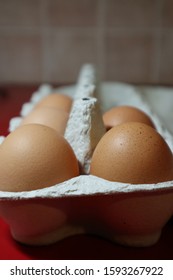 Opened box of eggs with 5 eggs