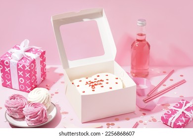 Opened box with tasty bento cake, gifts and zephyr on pink table. Valentine's Day celebration - Powered by Shutterstock