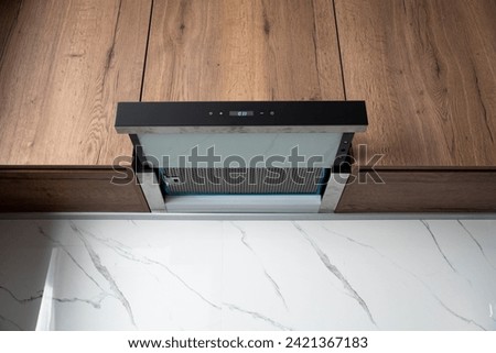Opened built in kitchen range hood on a wooden kitchen close up 商業照片 © 