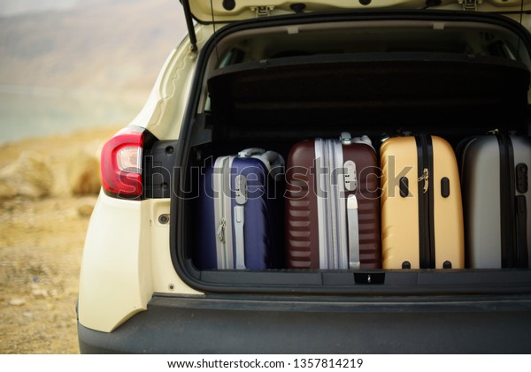 Opened car trunk full of\
suitcases, luggage, baggage. Summer holidays, travel, trip,\
adventure concept