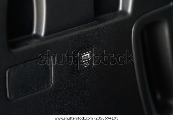 Opened car USB port\
in the car for connecting device. Power output of usb charger close\
up view. Car interior.