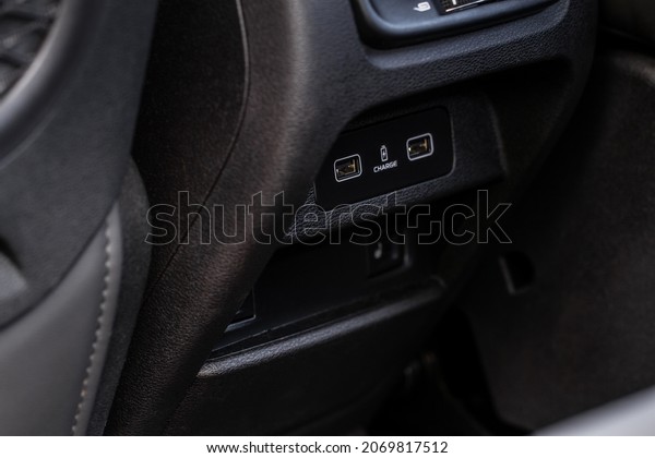 Opened car USB port\
in the car for connecting device. Power output of usb charger close\
up view. Car interior.