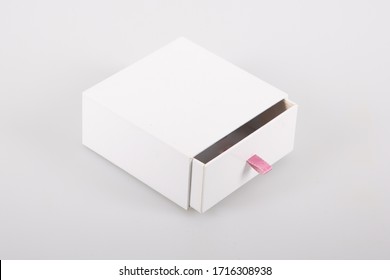Opened cardboard sliding box with drawer pink ribbon