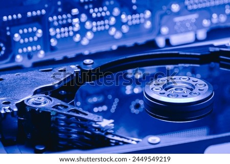 opened computer hard drive with reflections of circuit main board. selective focus.