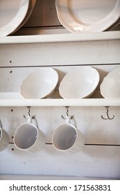 opened cupboard with kitchenware inside