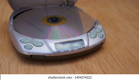 Opened Discman On Wooden Background. Cd Player. 