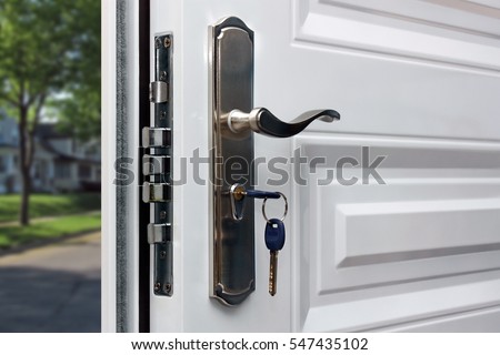 Opened door of a family home. Close-up of the lock with your keys on an armored front door. Security.