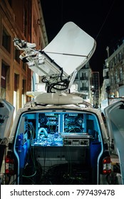 Opened Door Of Parked Satellite TV Van Transmitting Breaking News Events To Satellites For Broadcast Around The World At Night In City