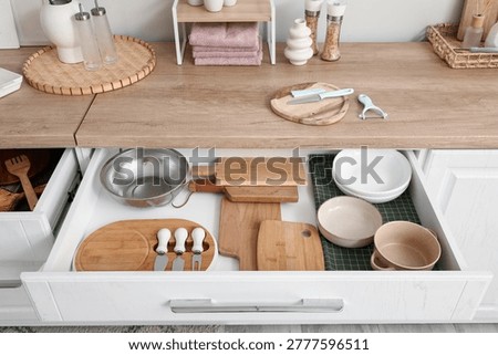 Opened drawer with utensils in kitchen