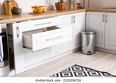 Opened drawers in modern kitchen interior