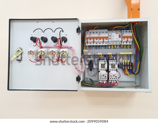 An opened of electrical panel board. Steel square\
box. Accessories such as miniature circuit breaker and earth\
leakage circuit breaker elcb. Colorful wire cable. Electricity.\
Malaysia. December 2021