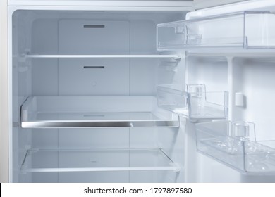 Opened Empty Refrigerator. Refrigerator Open Empty Fridge Inside Interior. Close Up On Empty Refrigerator With Door Open. New Clean Refrigerator.