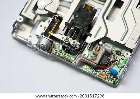 Opened floppy reader. Drive, motor, gears and other mechanisms, microcircuits. Disassembled floppy disk drive. Broken FDD 3.5 inch, repair of computer equipment