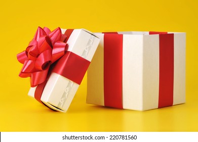 Opened Gift Box Close Up Isolated On Yellow Background 