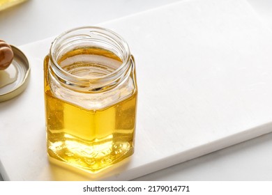 Opened Glass Jar Of Honey With Metal Lid On Table On A White Background. Superfood, Alternative Sugar Substitute.