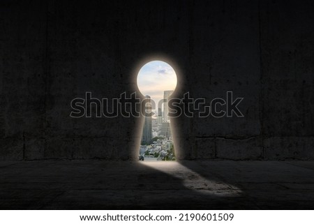 opened keyhole concrete wall. Cityscape view in the hole. Key to success and career growth concept