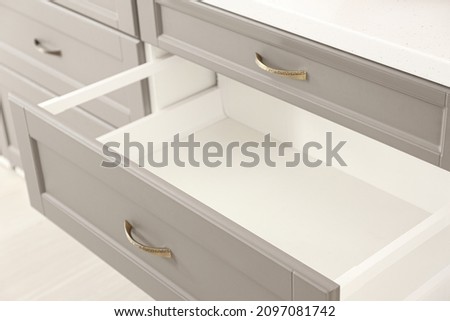 Opened kitchen drawer in room, closeup