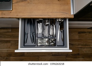Opened kitchen drawer with Stainless steel cutlery set