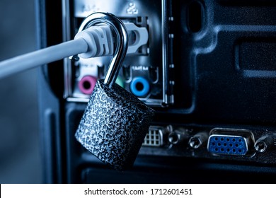Opened lock hanging on a network cable plugged into a computer. The concept of opening access, unlocking the Internet or hacking anti-virus protection or firewall by hackers. Theft of personal data.