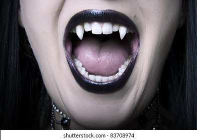 Opened Mouth With Long White Fangs Closeup Of Screaming Vampire Woman. Make Up For Halloween