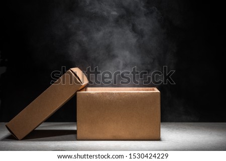 opened mystery box with smoke float up on dark background
