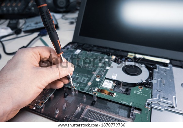 an\
opened notebook is repaired in a computer\
workshop