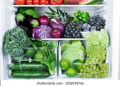 Opened refrigerator full of vegetarian healthy food, vibrant colour vegetables and fruits inside on fridge - Powered by Shutterstock