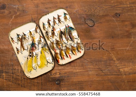 An opened Salmon fly box showing a selection of old salmon featherwing fishing flies circa 1900 with copy space to the right