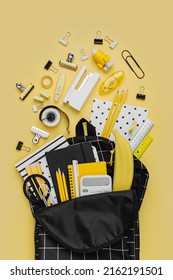 Opened School backpack with stationery on yellow background. Concept back to school. School supplies with black school bag. - Shutterstock ID 2162191501