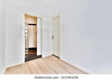 Opened Sliding White Door Of A Bathroom