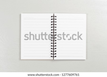 Opened small notebook on gray wood table