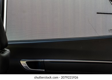 Opened sunshade. Car side window curtains sunshades. Sunblind curtain in a modern car.