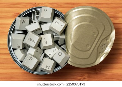 Opened tin can full of computer keyboard keys. Conceptual image.